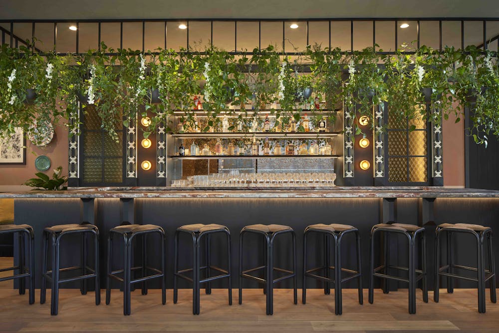 a living room filled with furniture and vase of flowers on a table