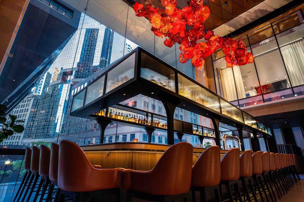 a living room filled with furniture and vase of flowers on a table