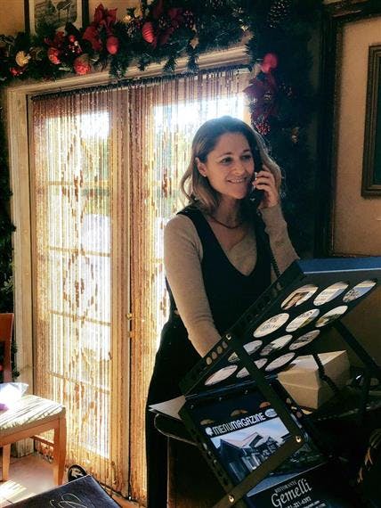 a woman sitting in a chair talking on the phone