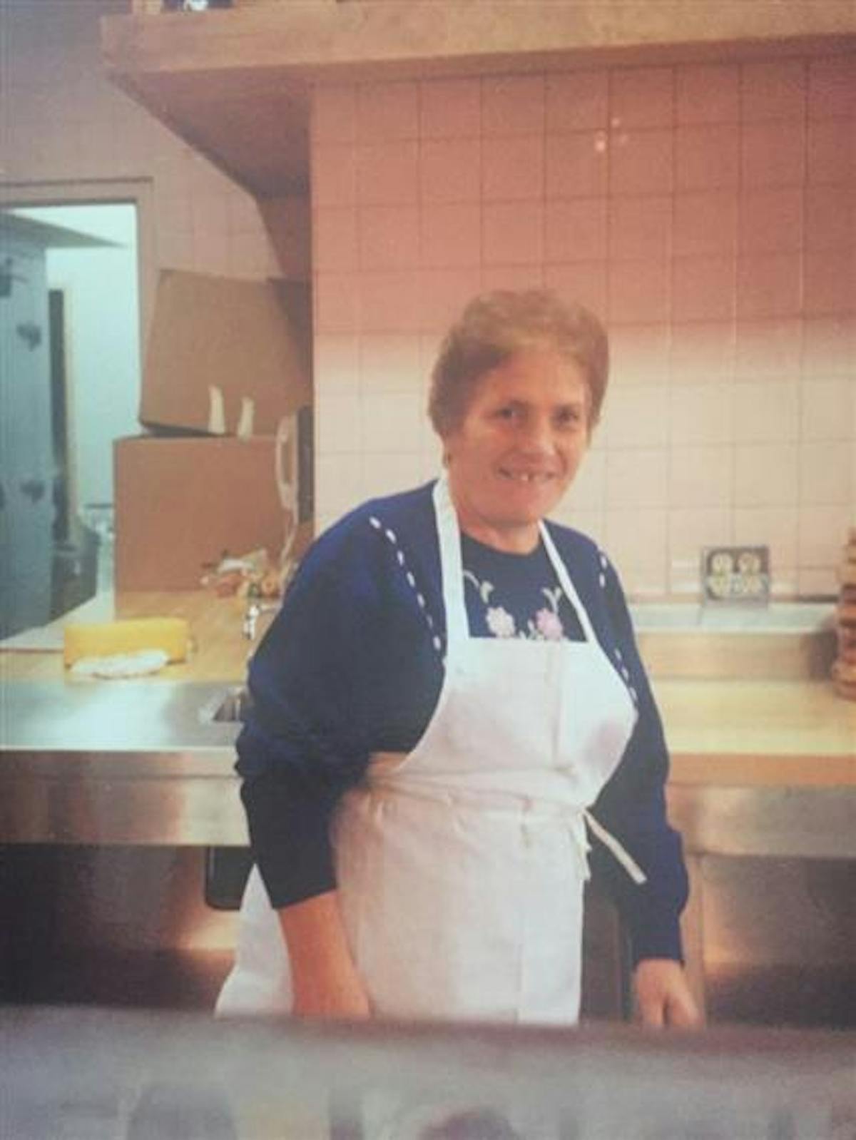 a boy standing in a kitchen