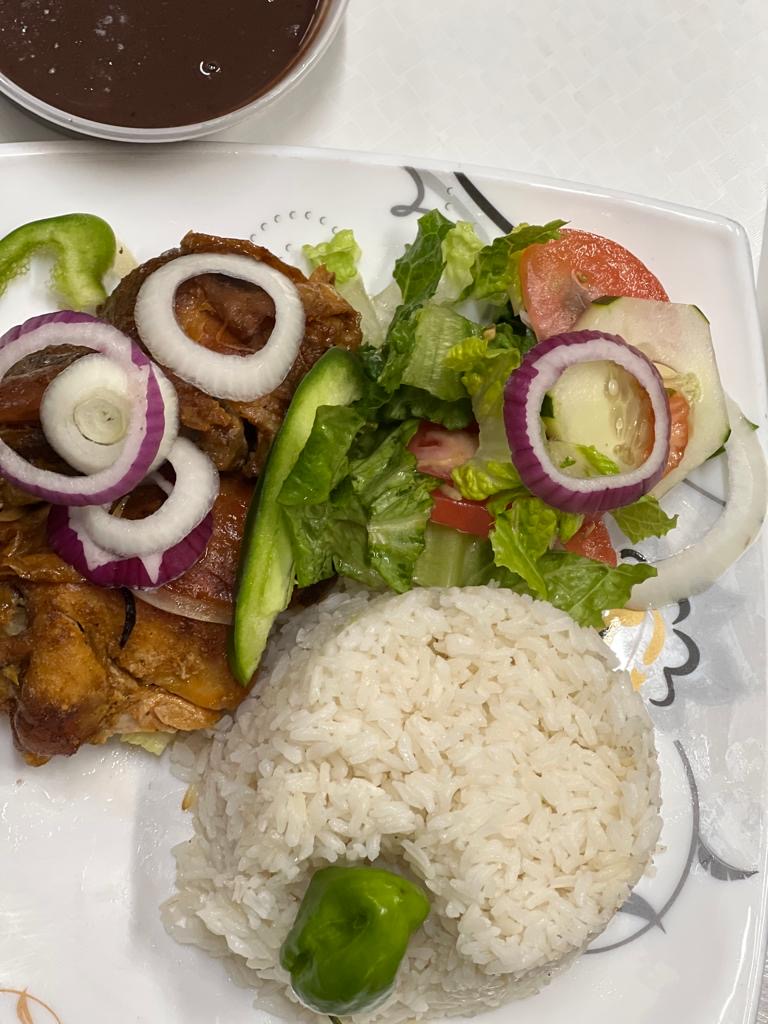a plate of food with rice meat and vegetables