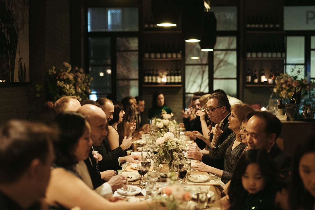 a group of people sitting at a table in a restaurant