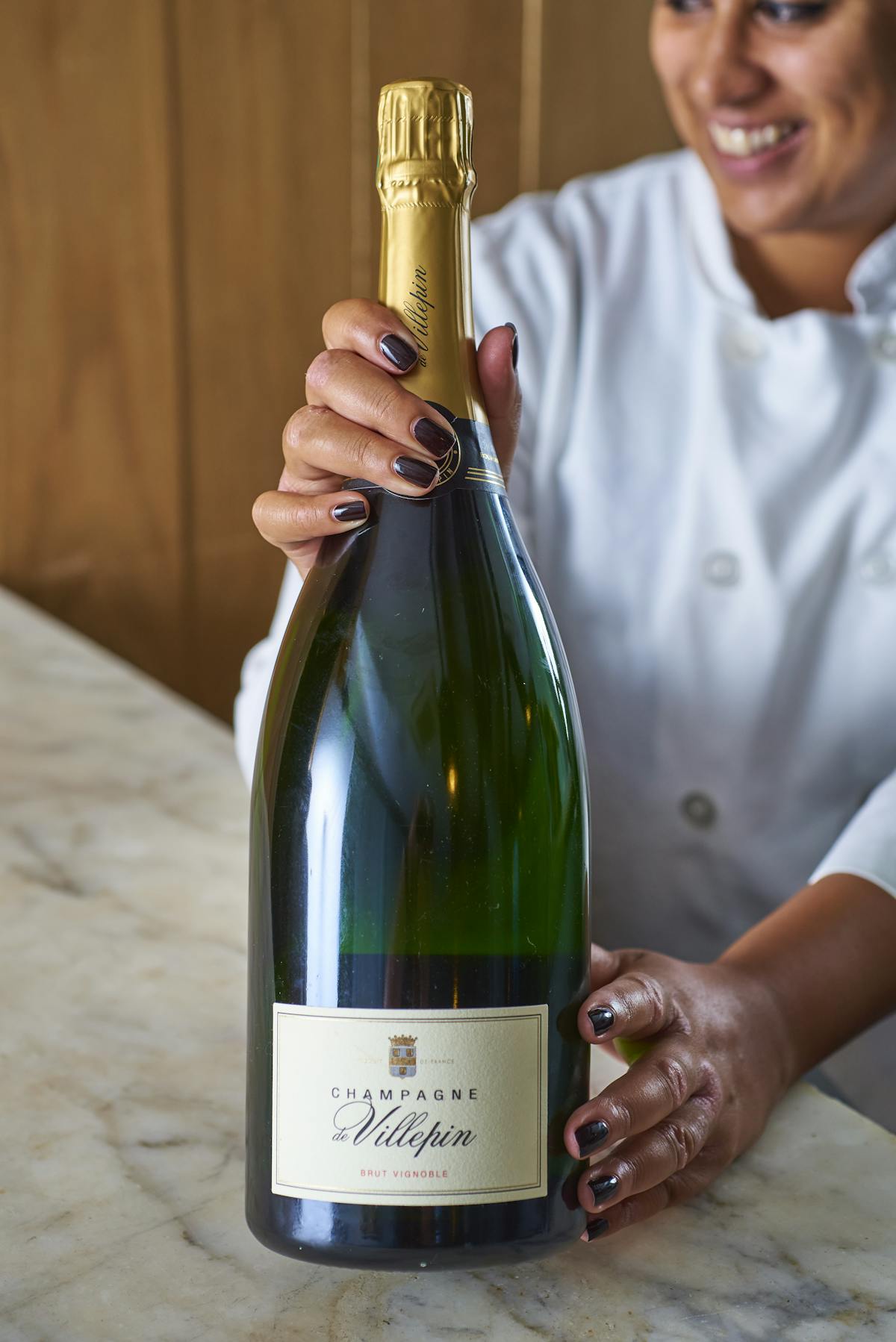 a person holding a bottle of wine