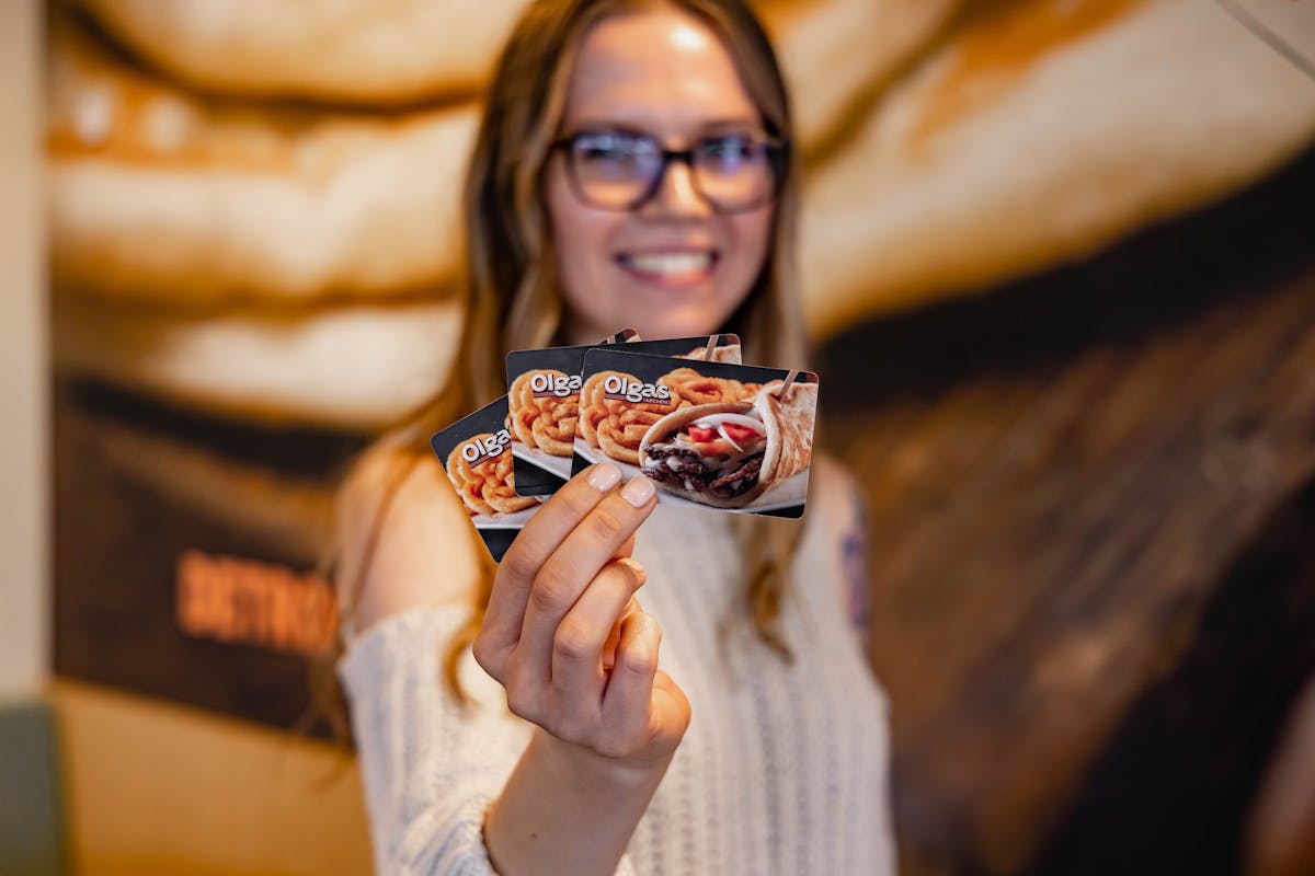 a person holding gift cards