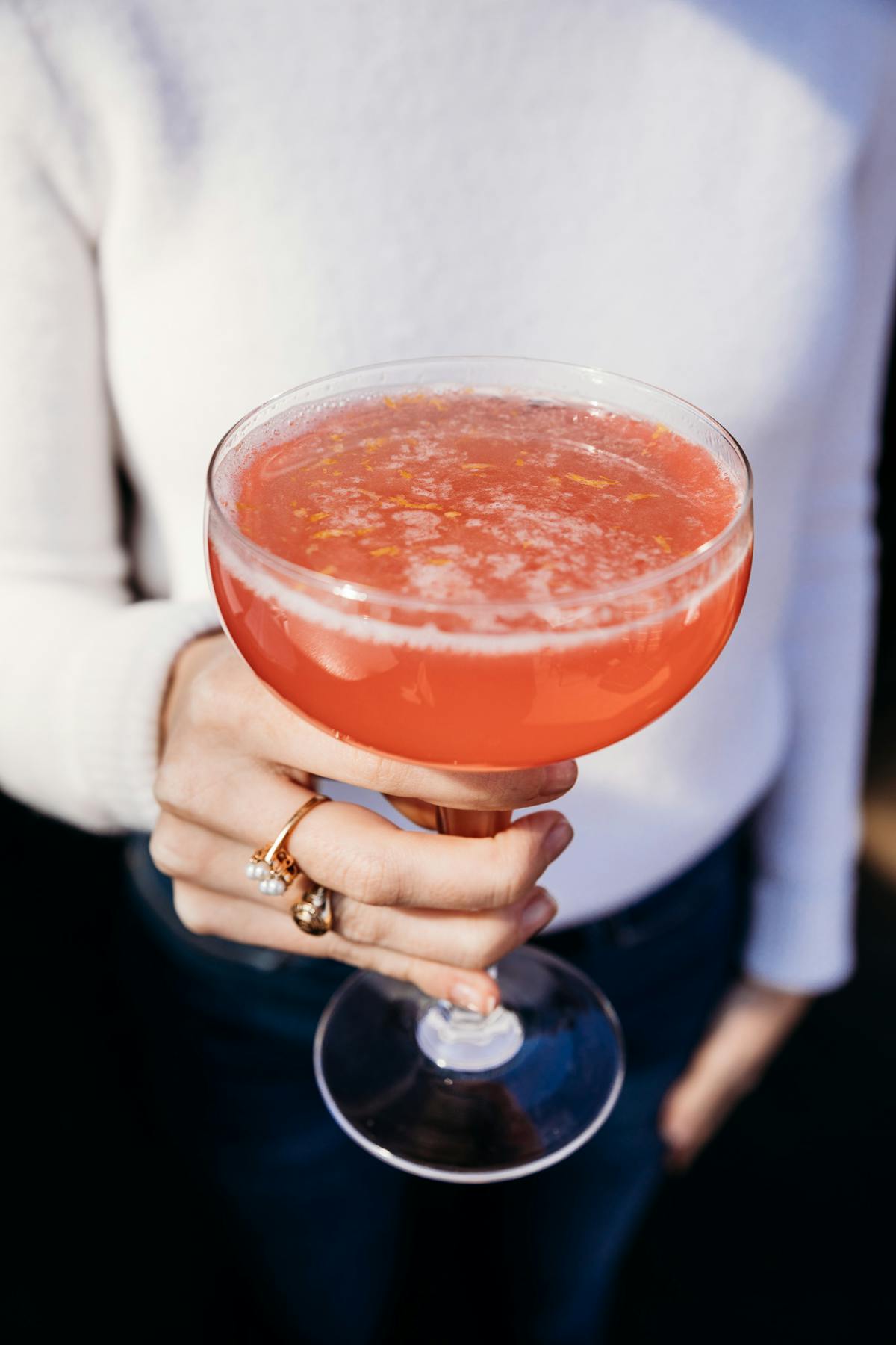 a person holding a cocktail