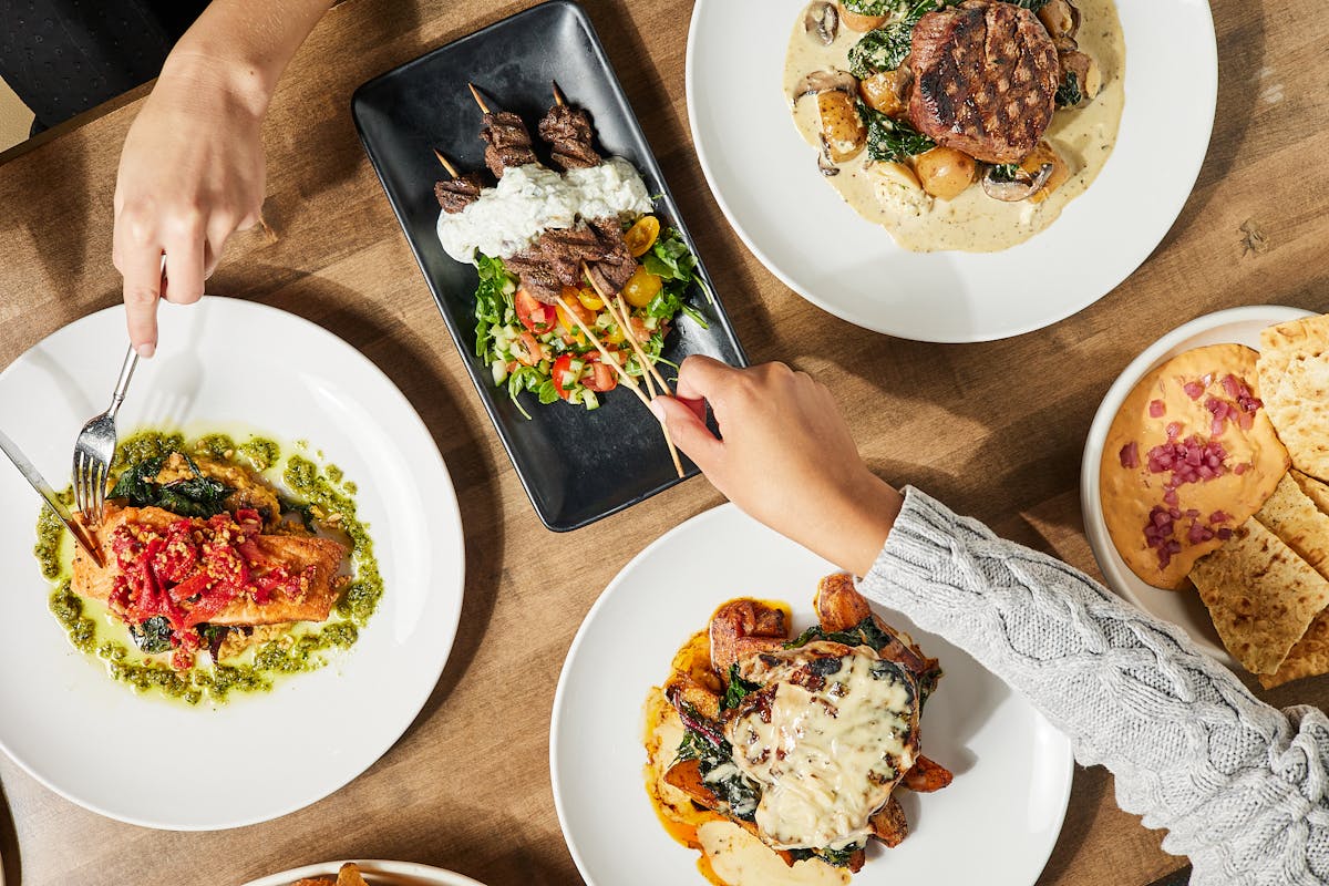 a plate topped with different types of food on a table
