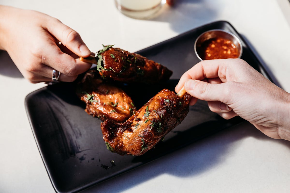 people holding pieces of food