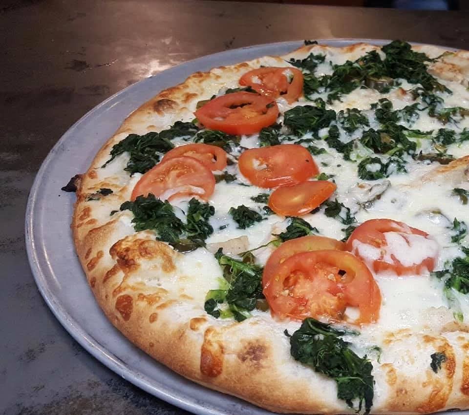 a pizza sitting on top of a plate of food