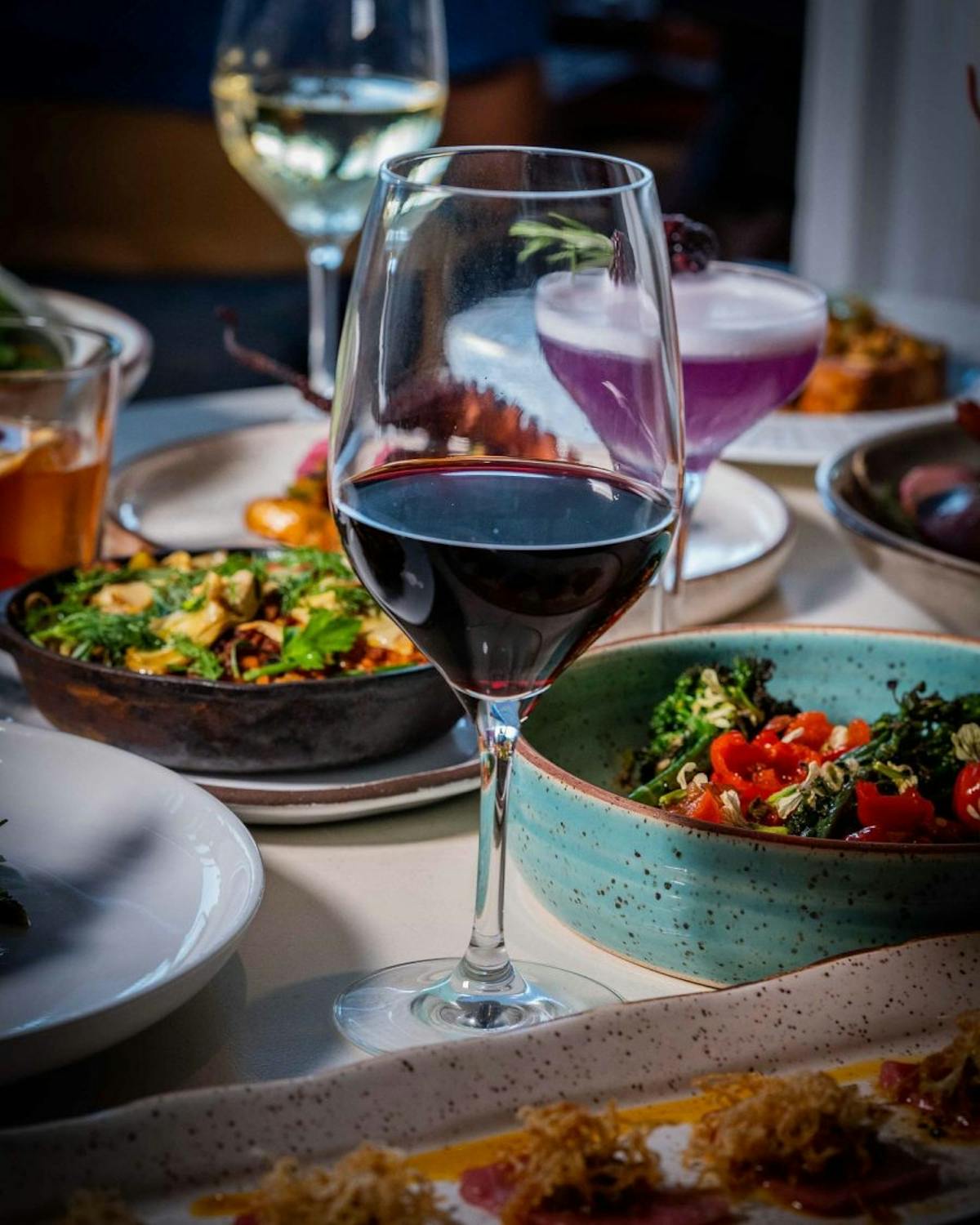 a plate of food and glasses of wine