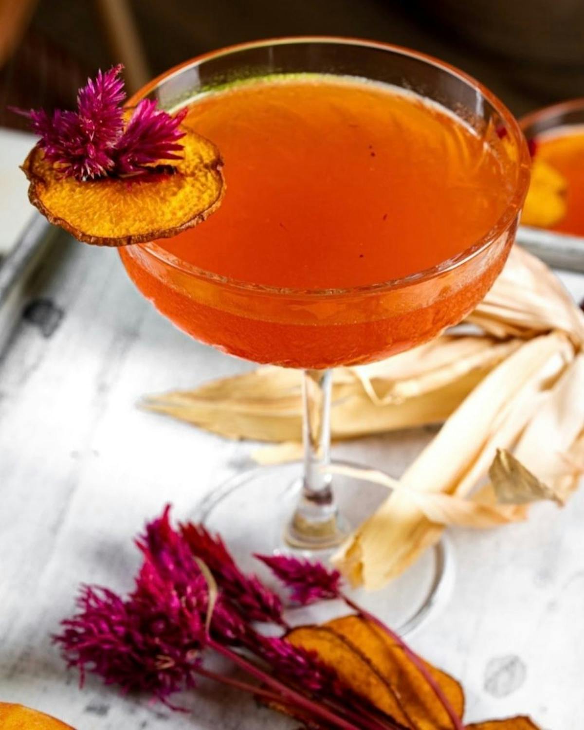 a glass of orange juice on a table