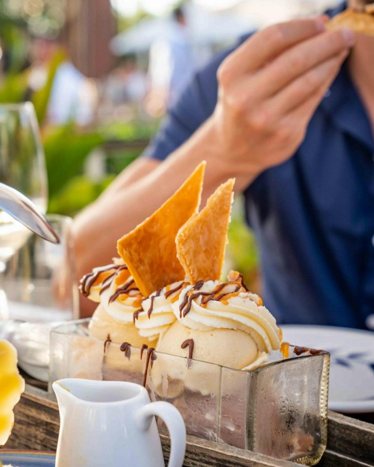 a close up of a person holding a cup of coffee on a table