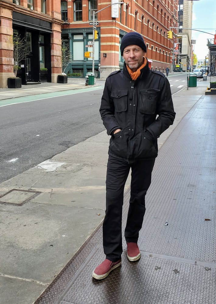 a man standing on a sidewalk