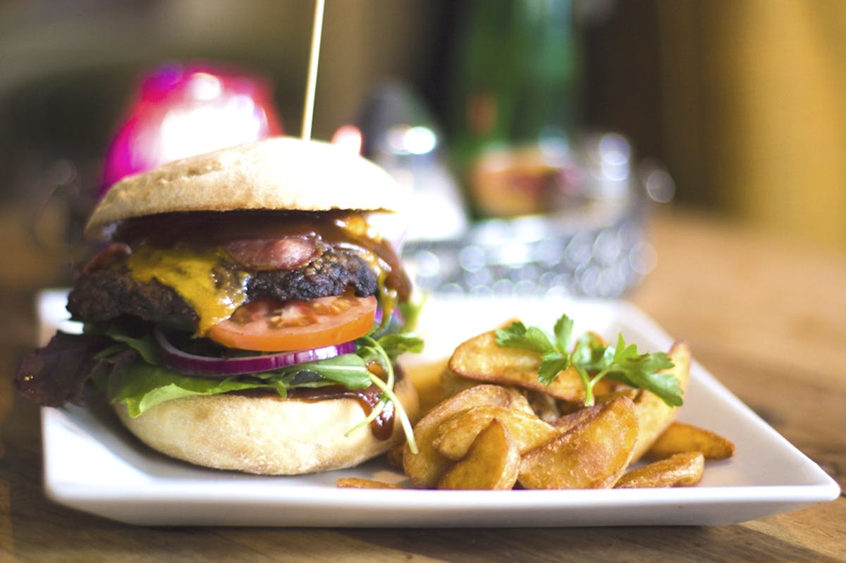 hamburger topped with fresh lettuce and tomato