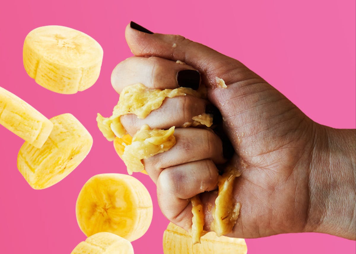 a hand holding a banana that could be a blender