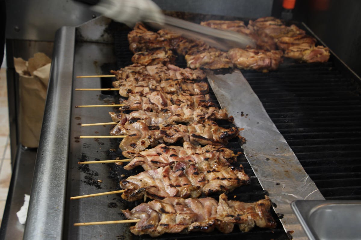 bbq meat skewers cooking on a grill