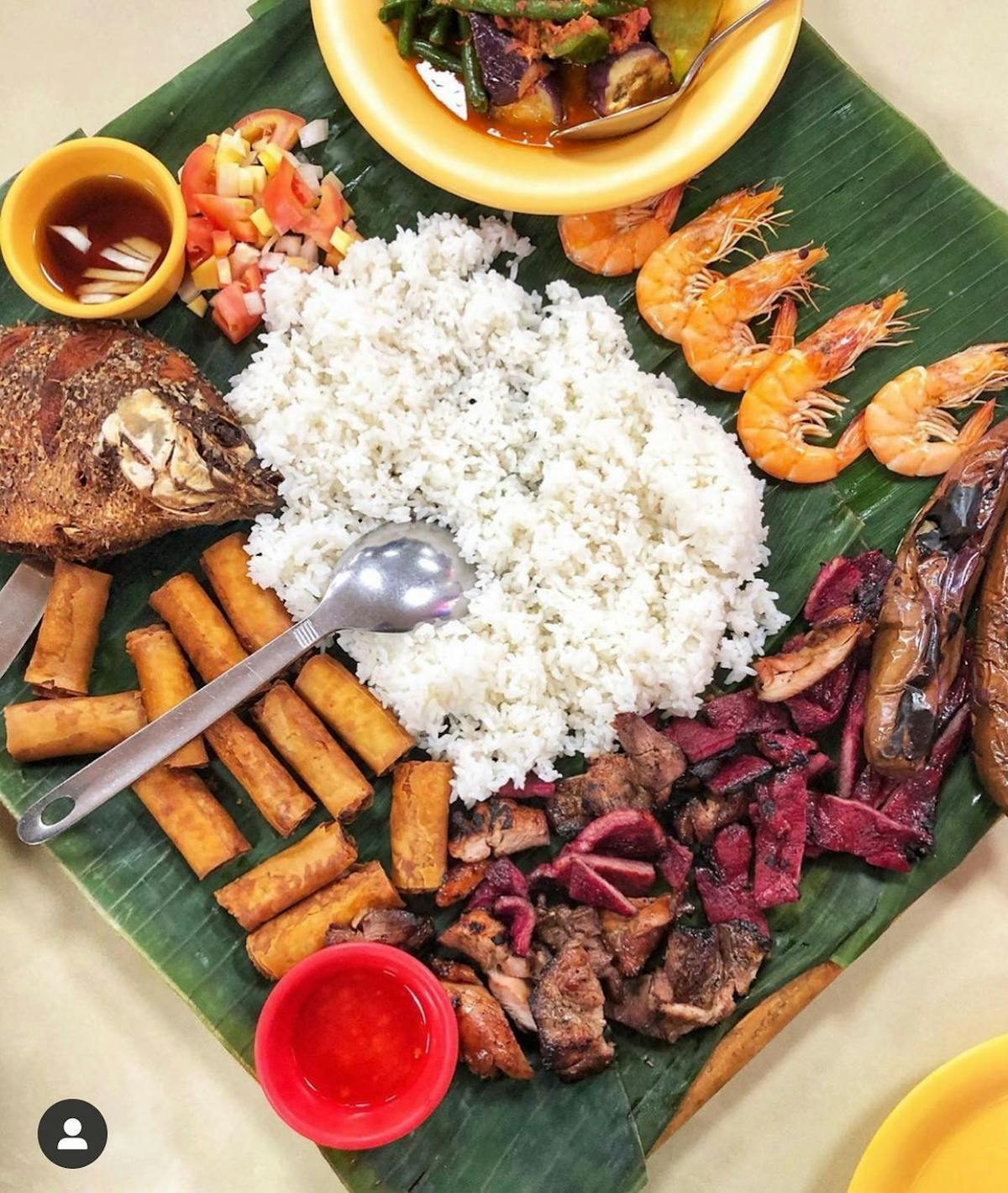 a platter of food on a banana leaf