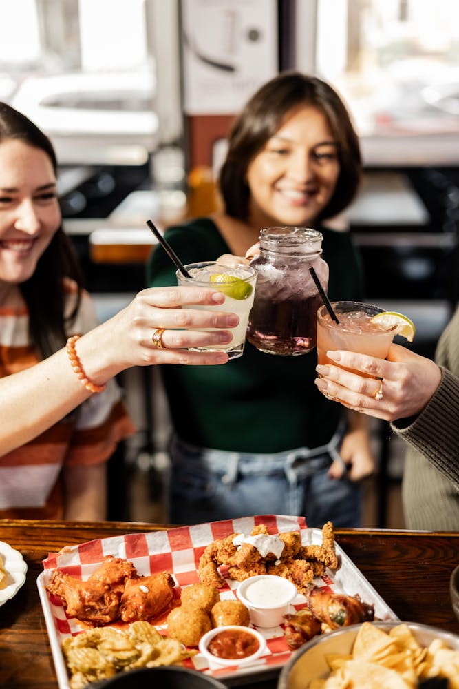 a woman sitting at a table with a plate of food