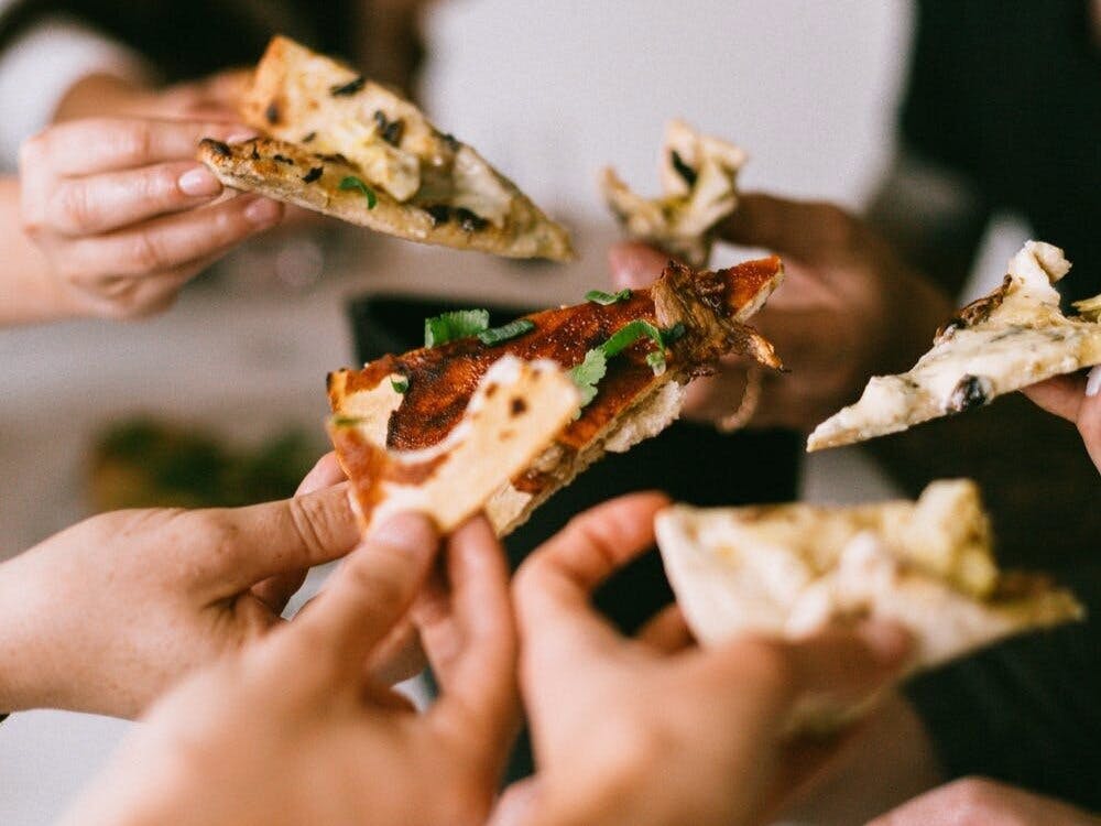 a hand holding Best Pizza in Dallas