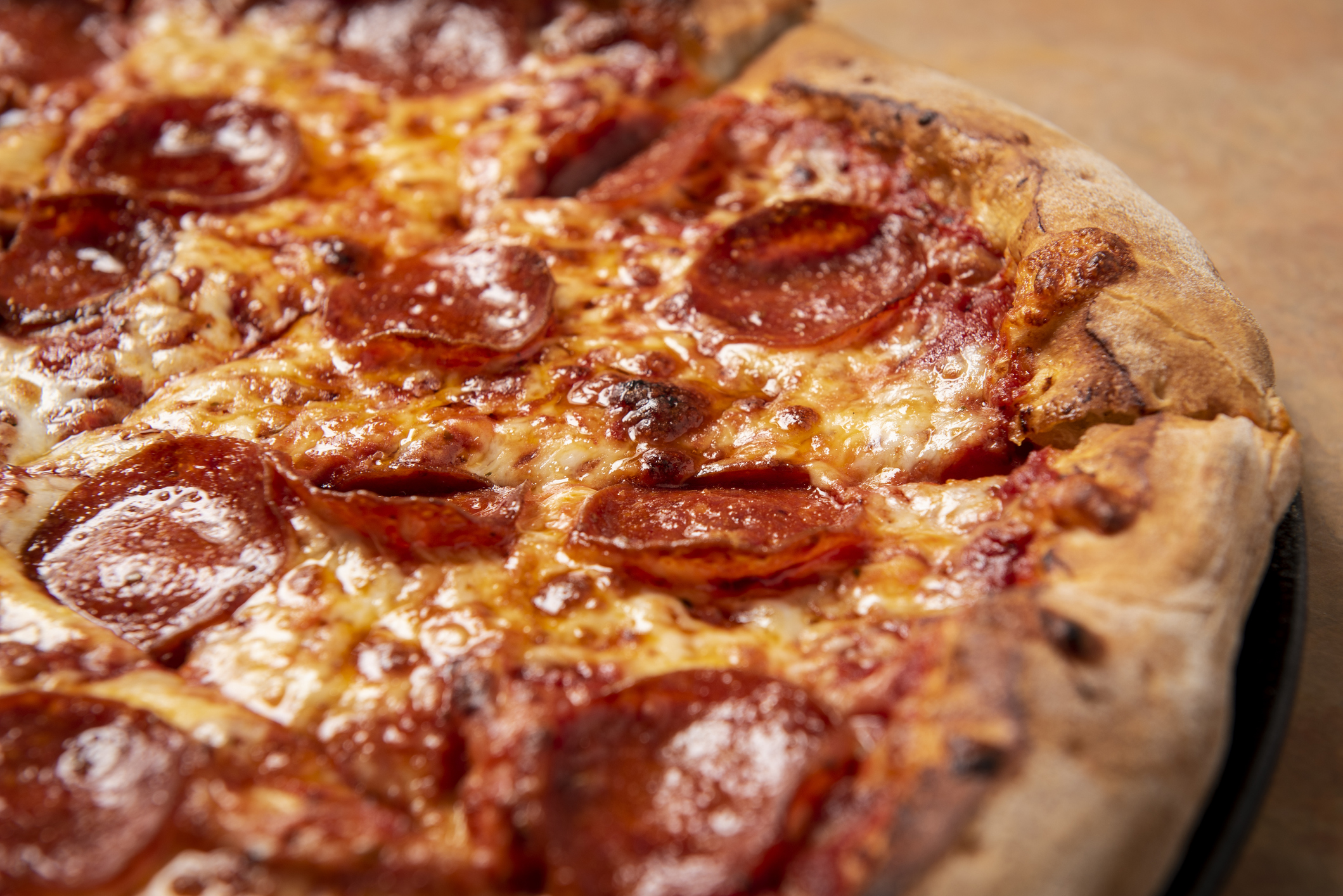 a pizza sitting on top of a wooden cutting board
