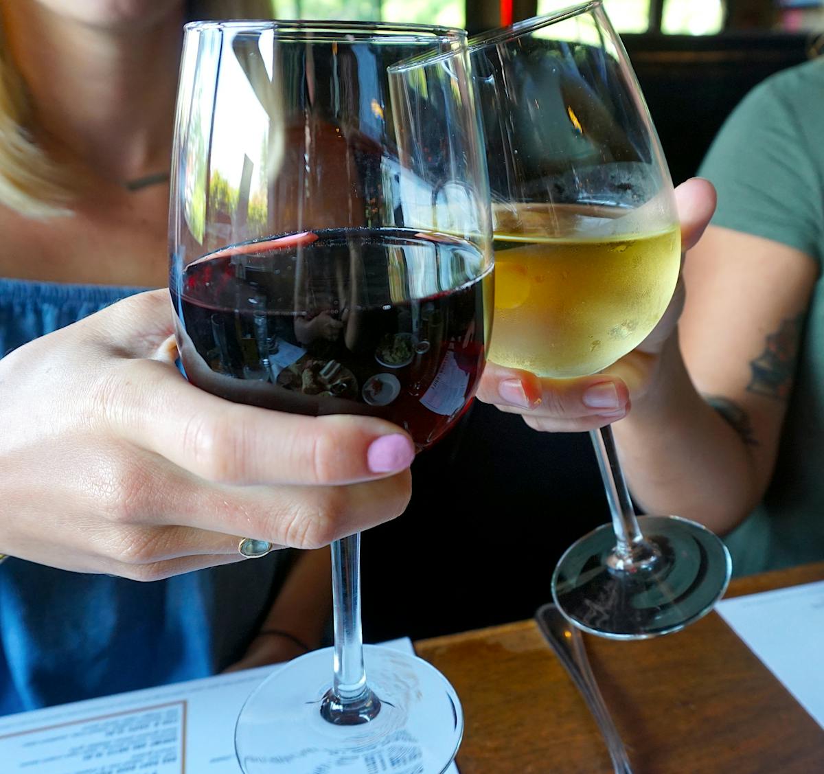 a hand holding a glass of wine