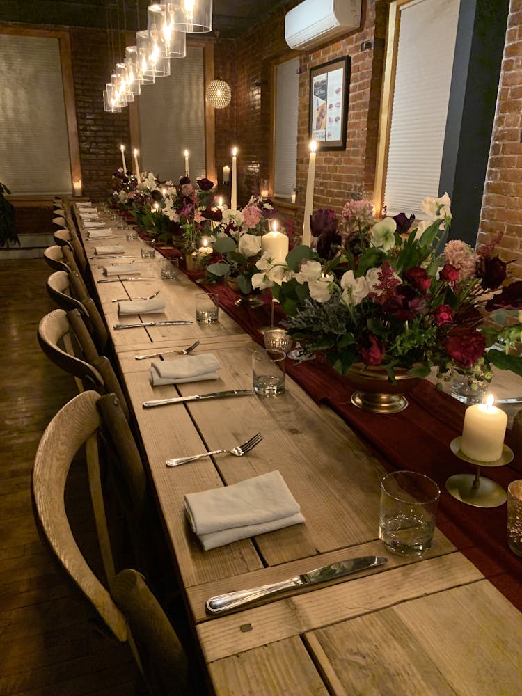 a room filled with furniture and vase of flowers on a table