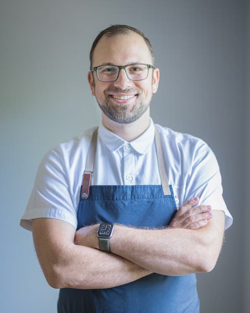 a man wearing glasses and a blue shirt