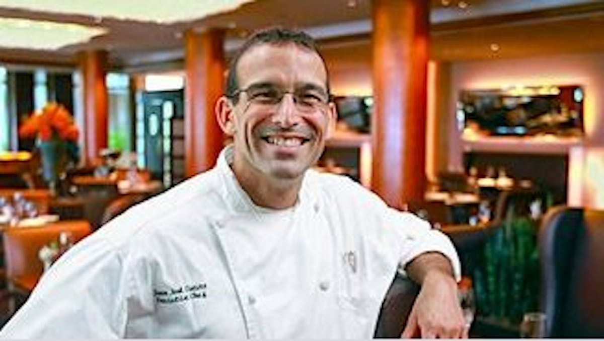 a man standing in front of a restaurant