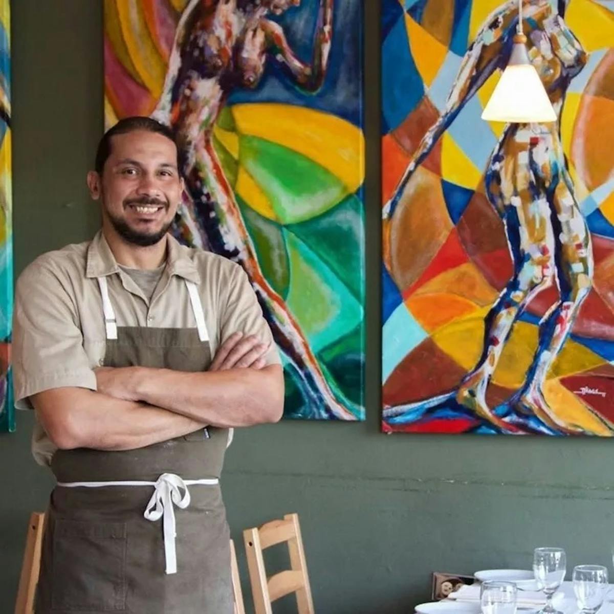 a person standing next to a painting