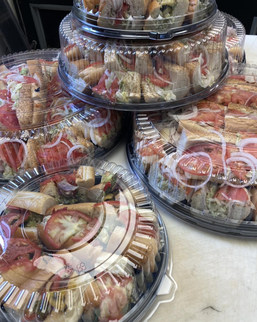 a photo of four catering sandwich platters