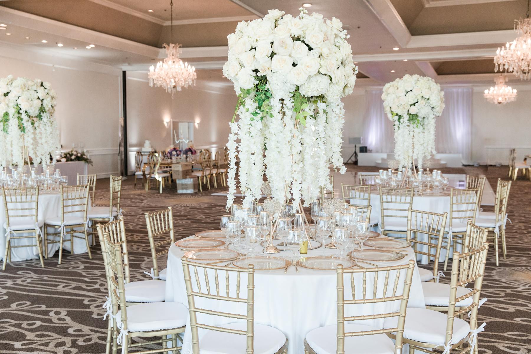 a room filled with furniture and vase of flowers on a table