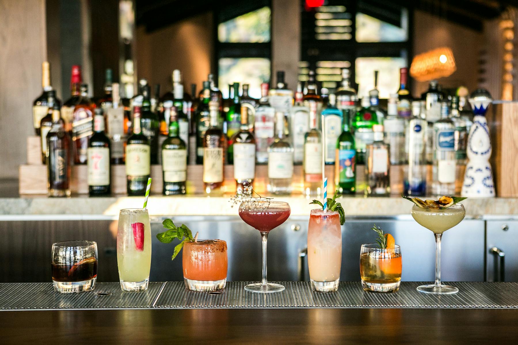 a line up of cocktails at the bar