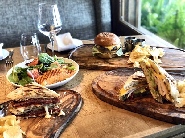a wooden table topped with plates of food on a plate