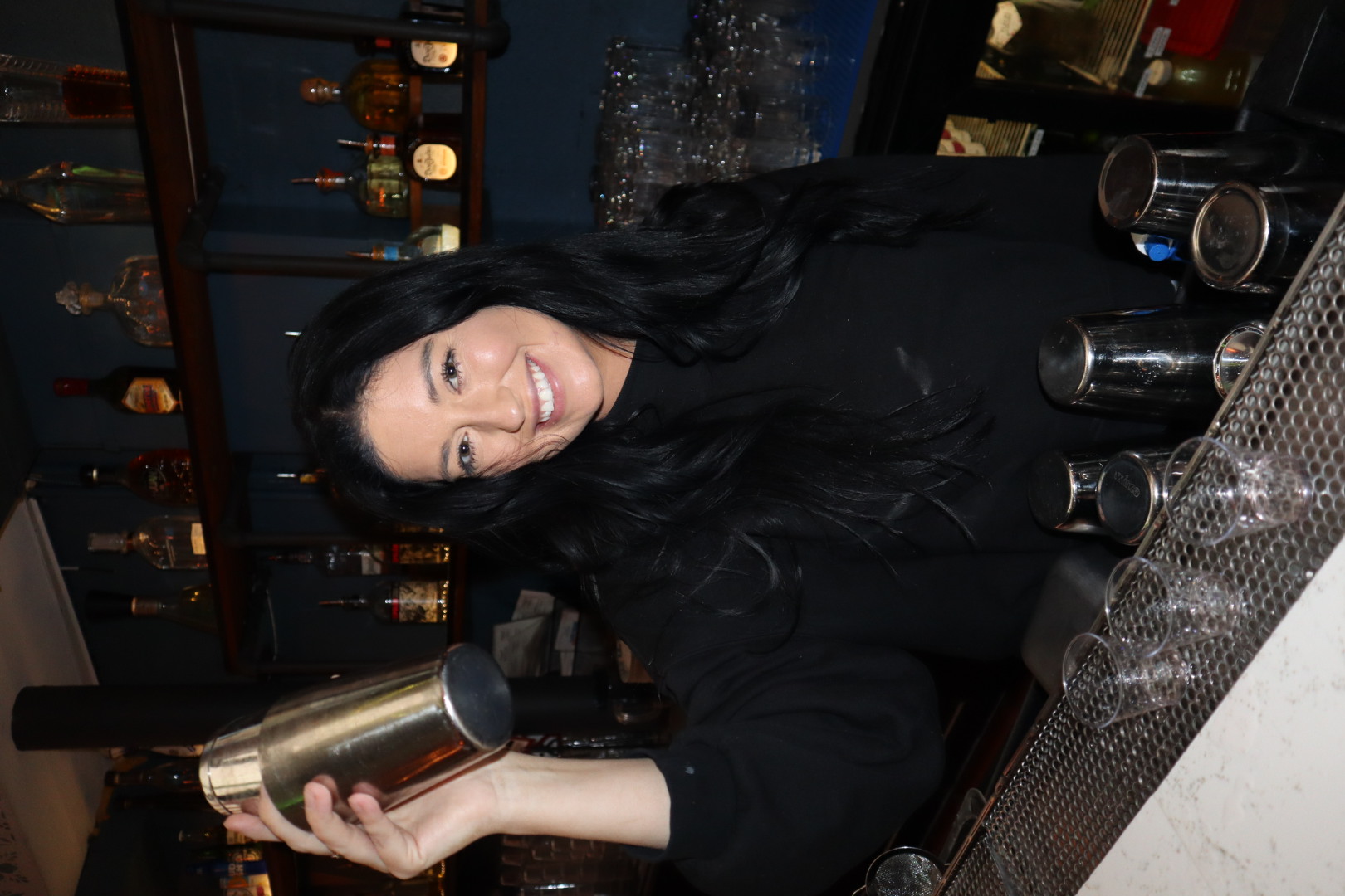 a person sitting at a table with wine glasses