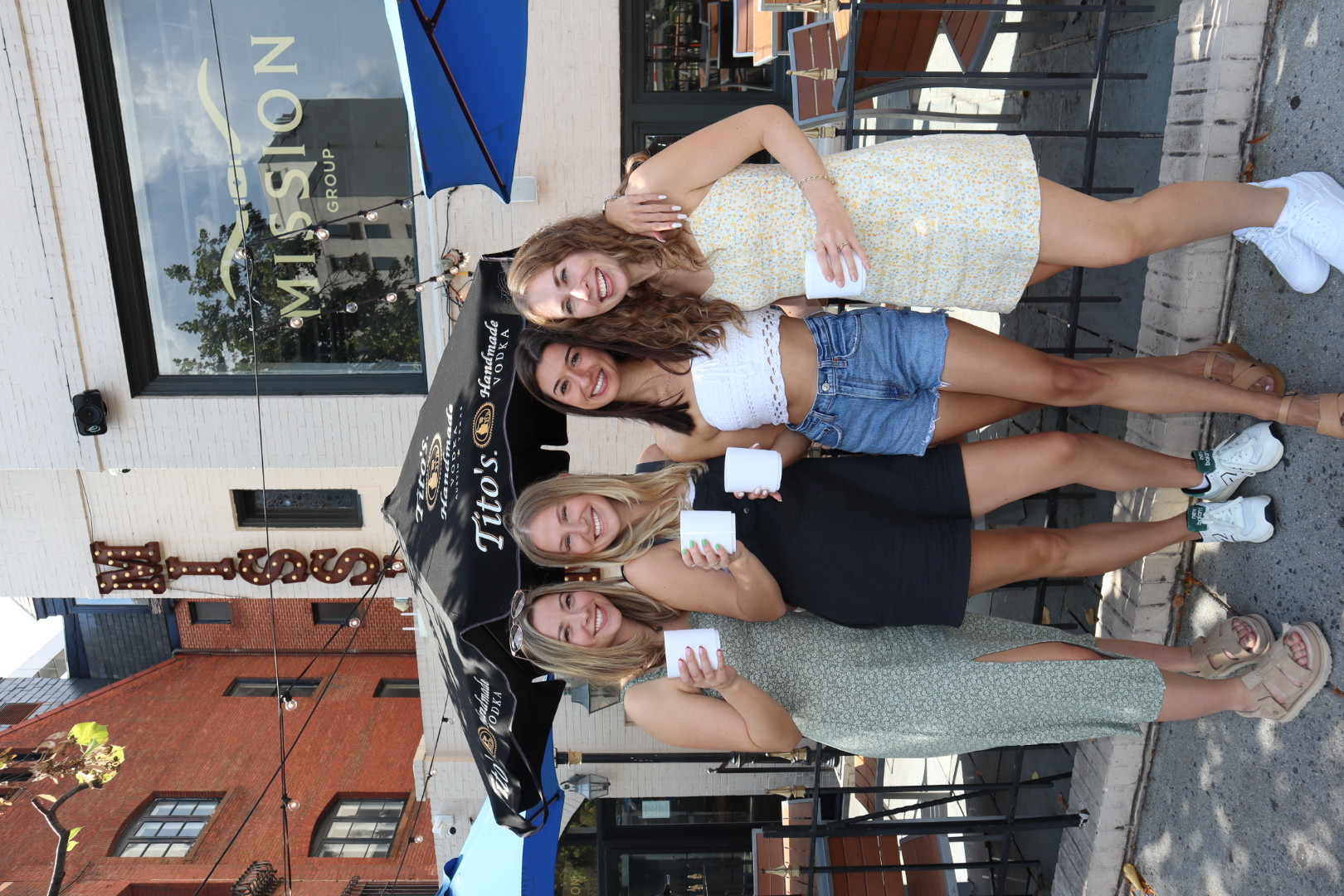 a person standing in front of a group of people posing for the camera