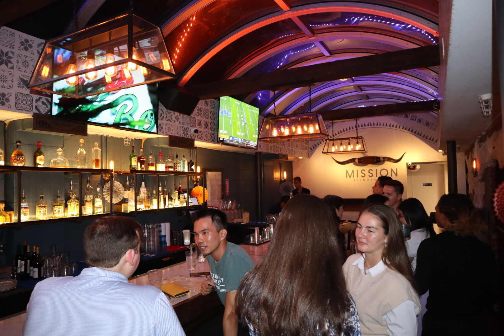 a group of people sitting at a table in a restaurant