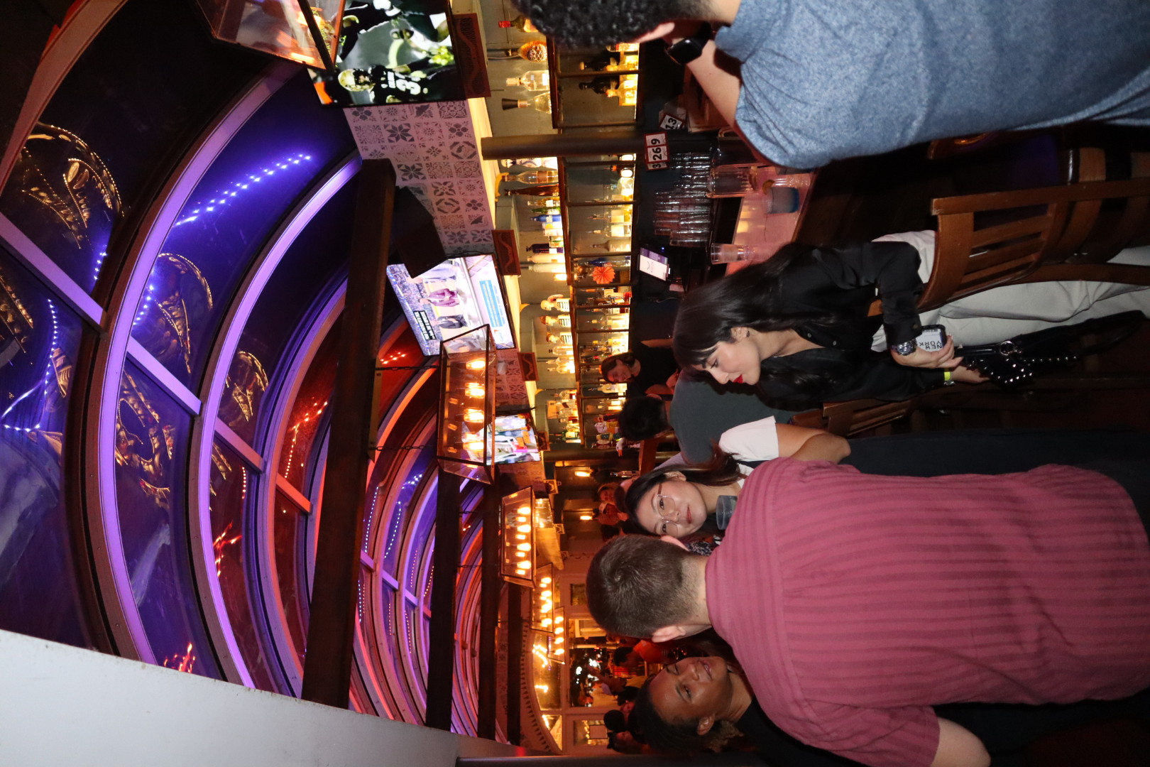 a group of people standing in front of a restaurant