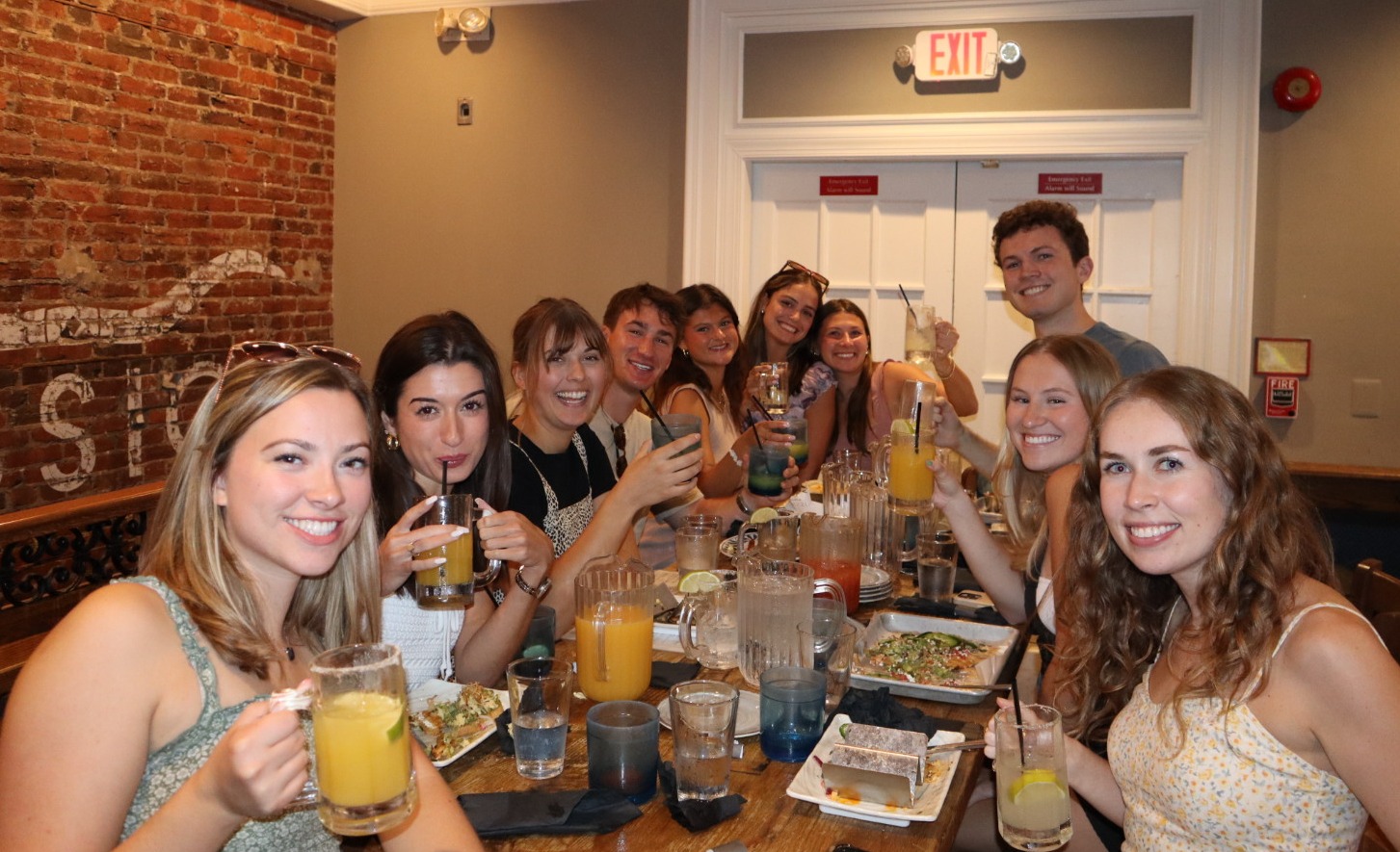 a group of people sitting at a table posing for the camera