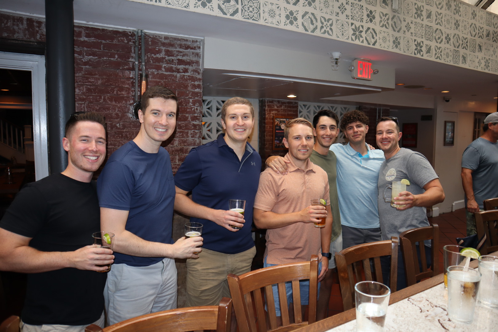 a group of people standing around a table posing for the camera