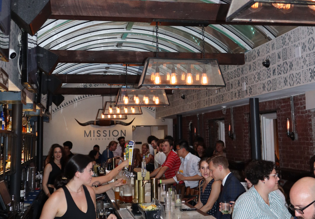 a group of people sitting at a bar