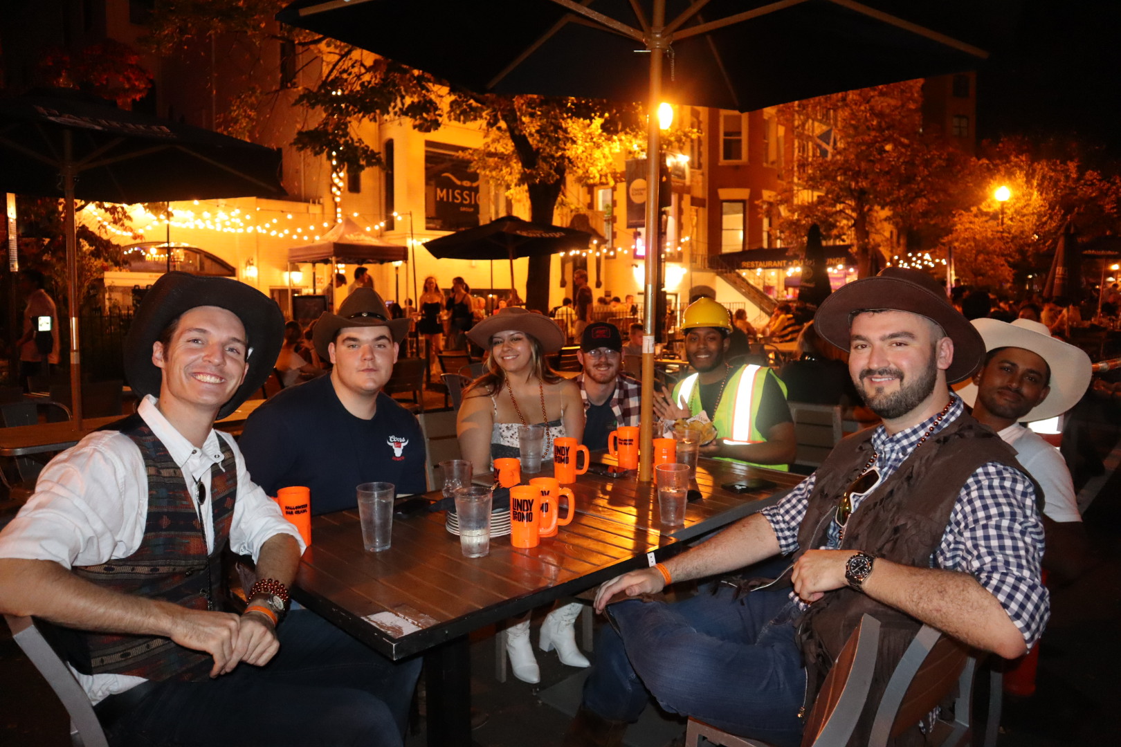 a group of people sitting at a table in a restaurant