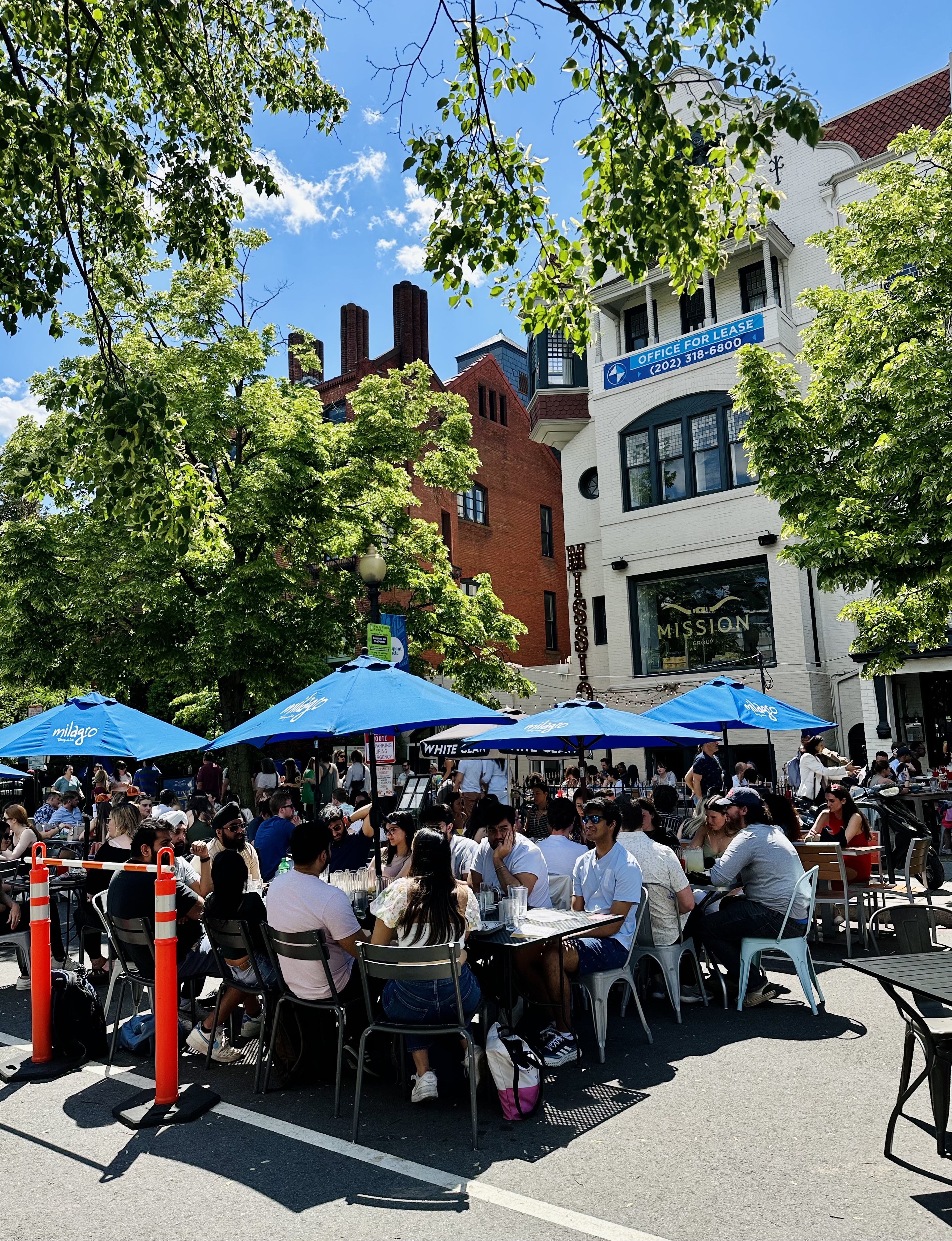 a group of people walking down the street in front of a crowd