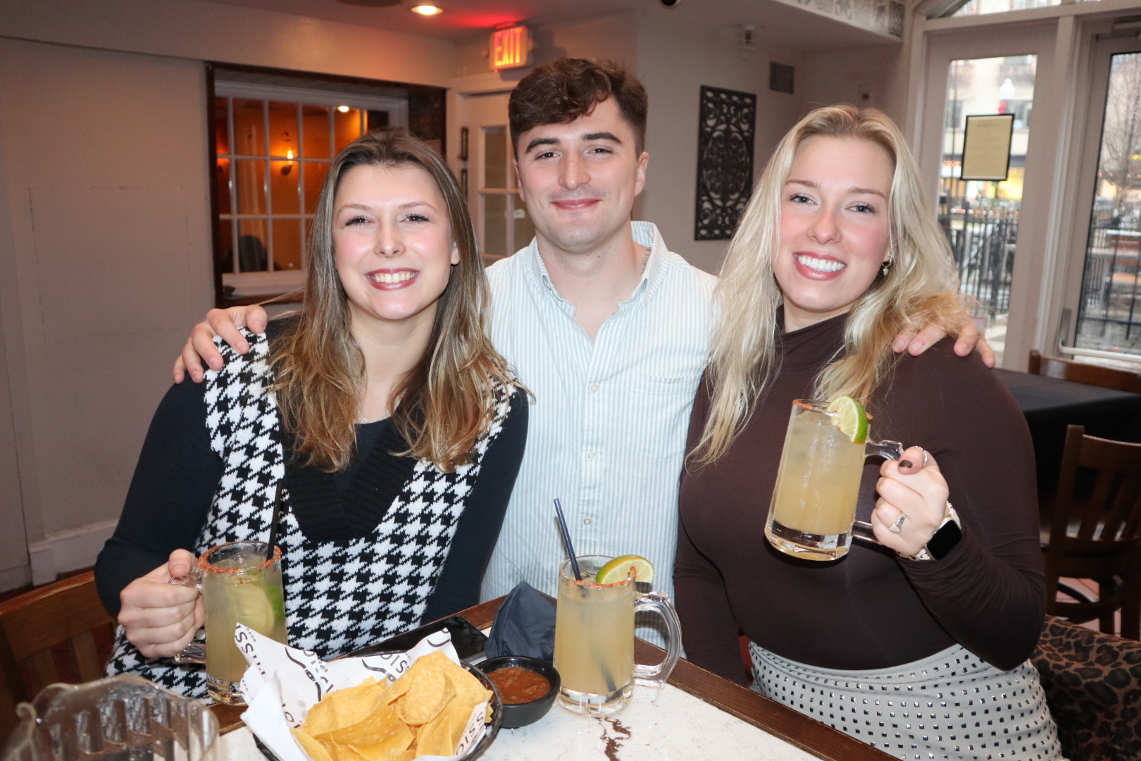 a man and a woman sitting at a table posing for the camera