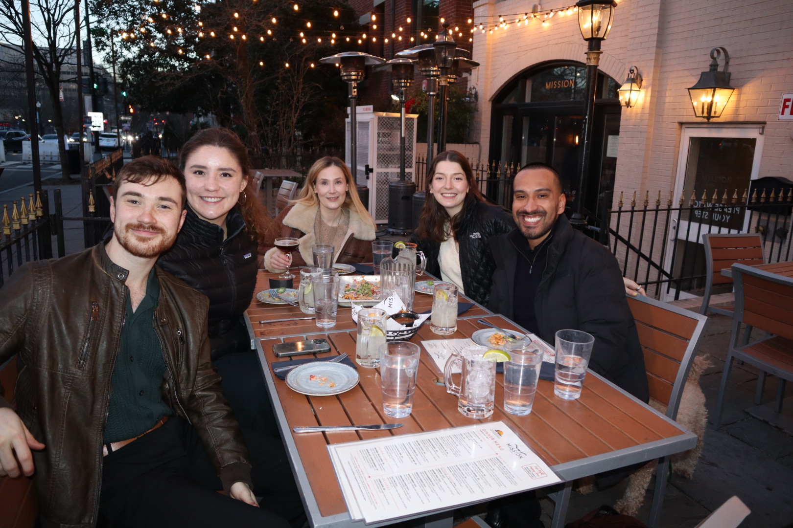 a group of people sitting at a table with wine glasses