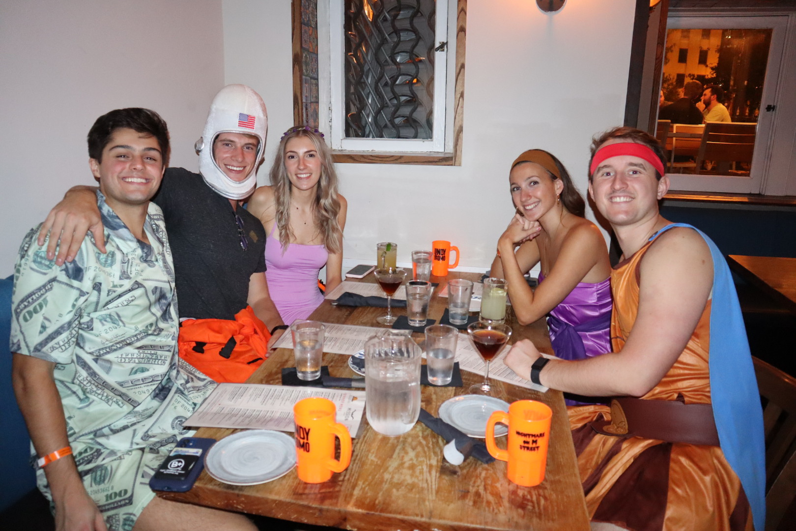 a group of people sitting at a table posing for the camera
