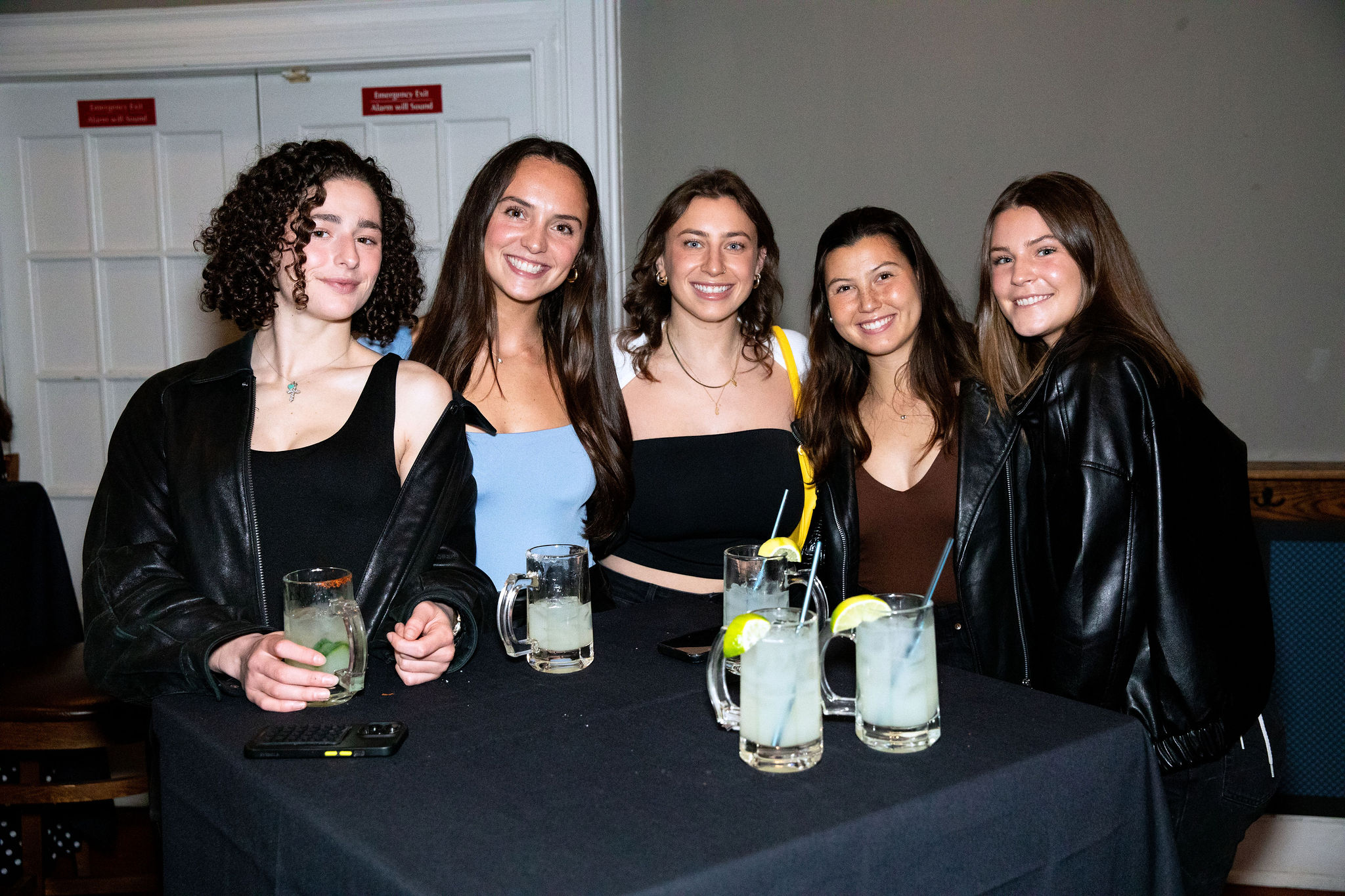 a couple of people sitting at a table posing for the camera