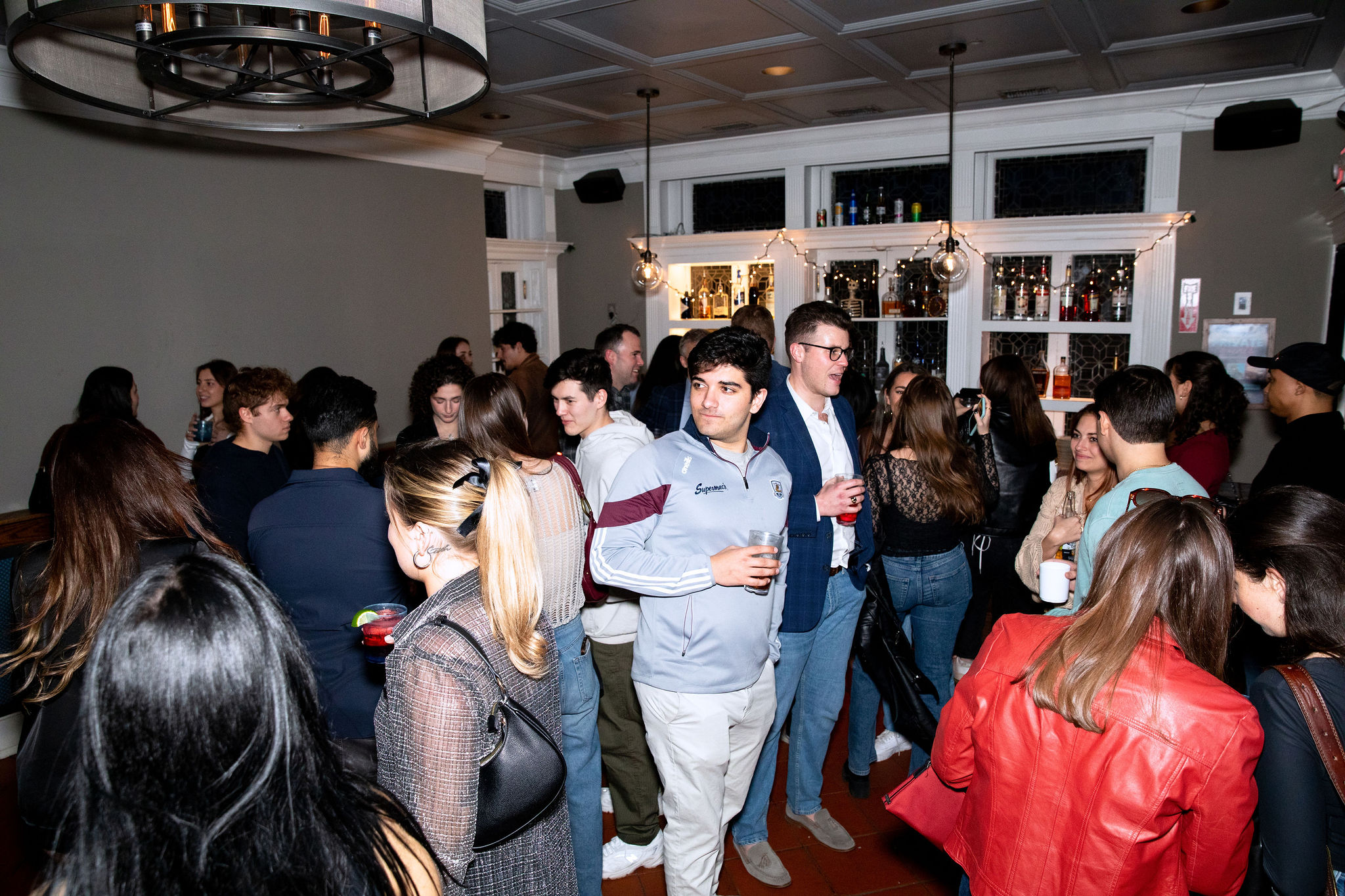 a group of people standing in front of a crowd posing for the camera