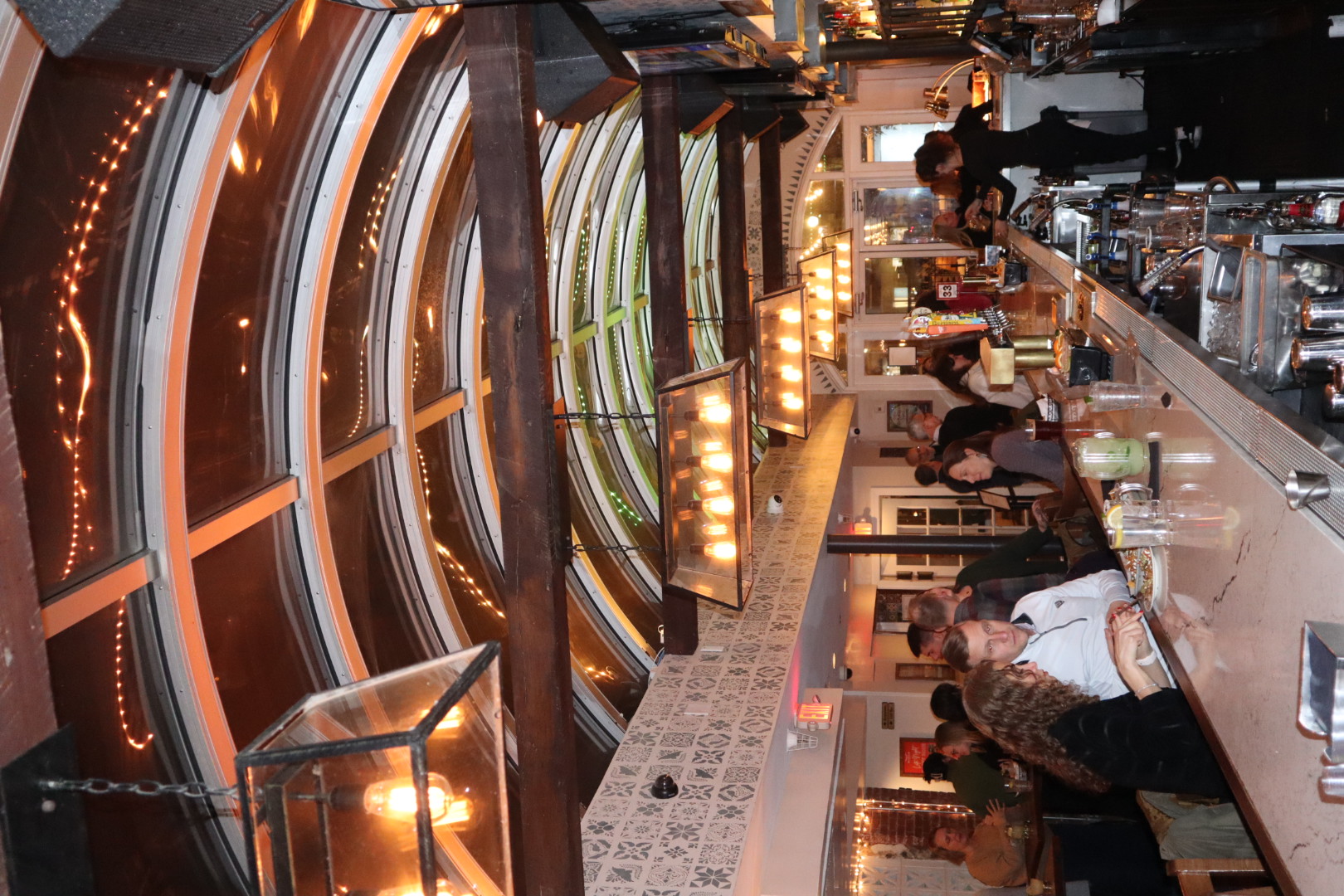 a group of people sitting at a table in a restaurant