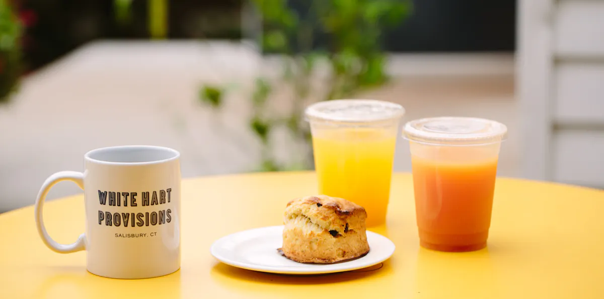 a glass of orange juice next to a cup of coffee