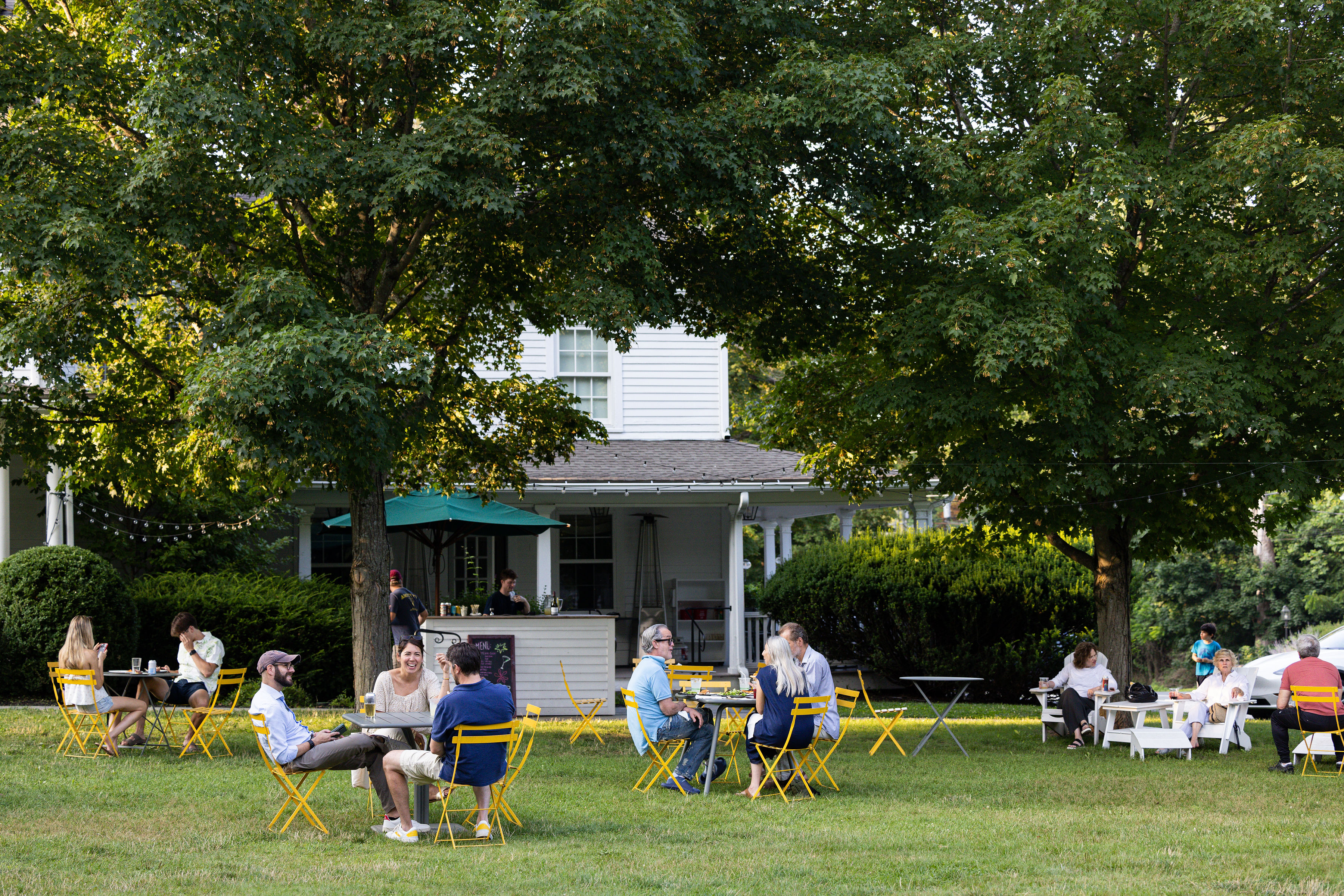 a group of lawn chairs sitting on top of a grass covered field