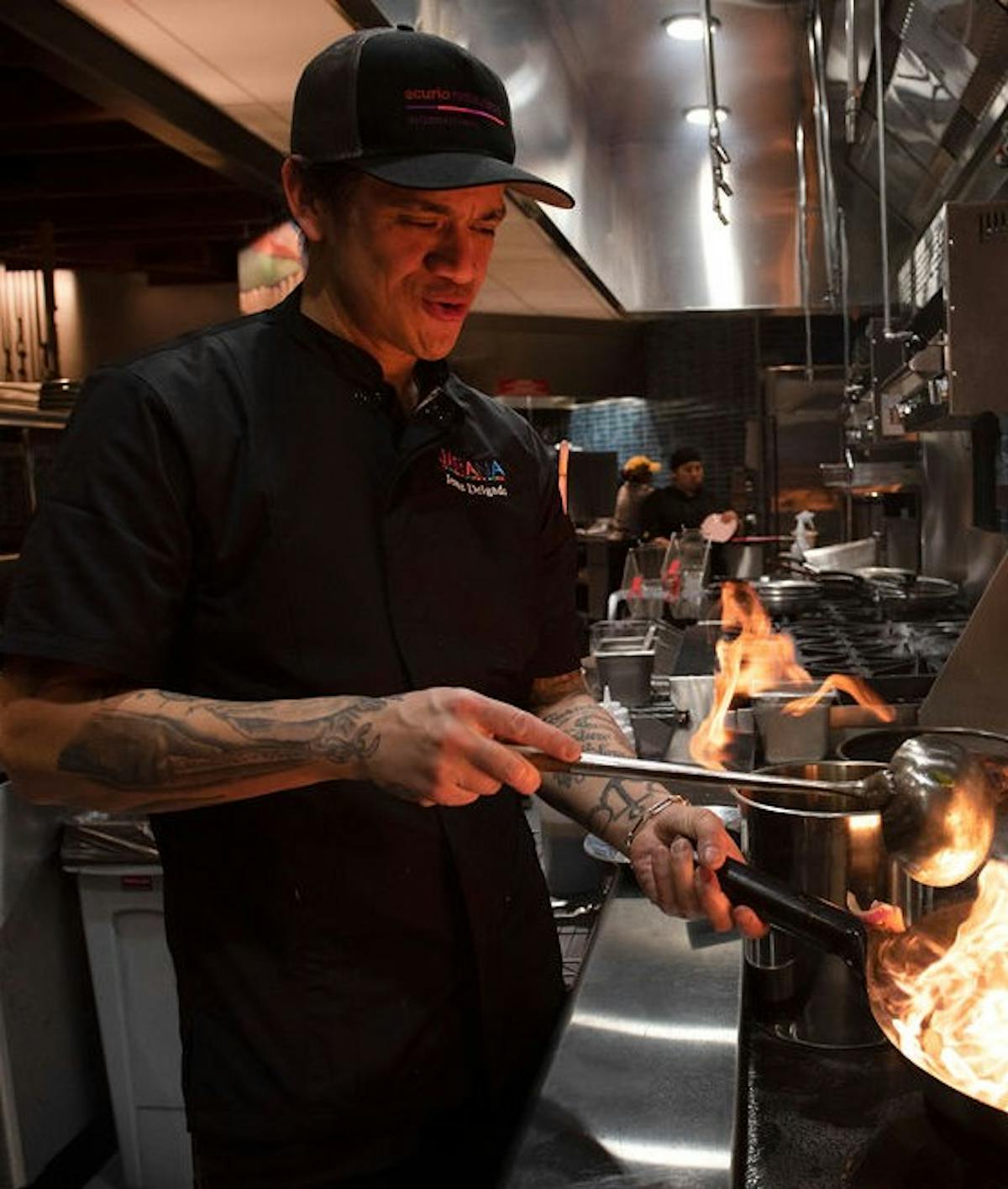 a man cooking in a kitchen preparing food